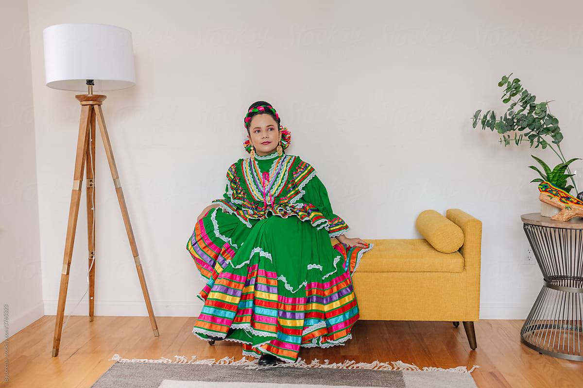 Portrait girl dressed up with a traditional Mexican dress and braid hairstyle