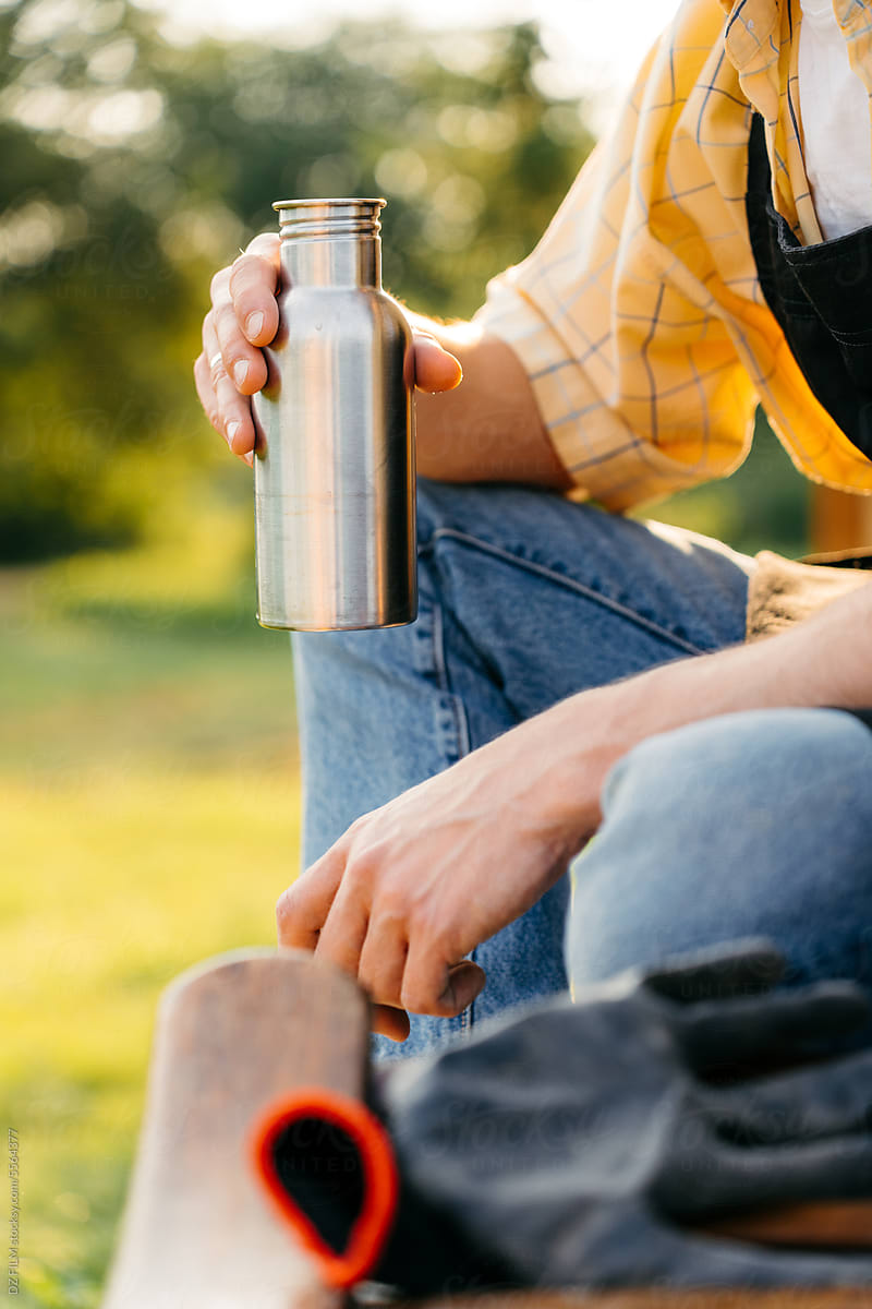 Men Hand With Thermos Flask Outdoors by Stocksy Contributor DZ
