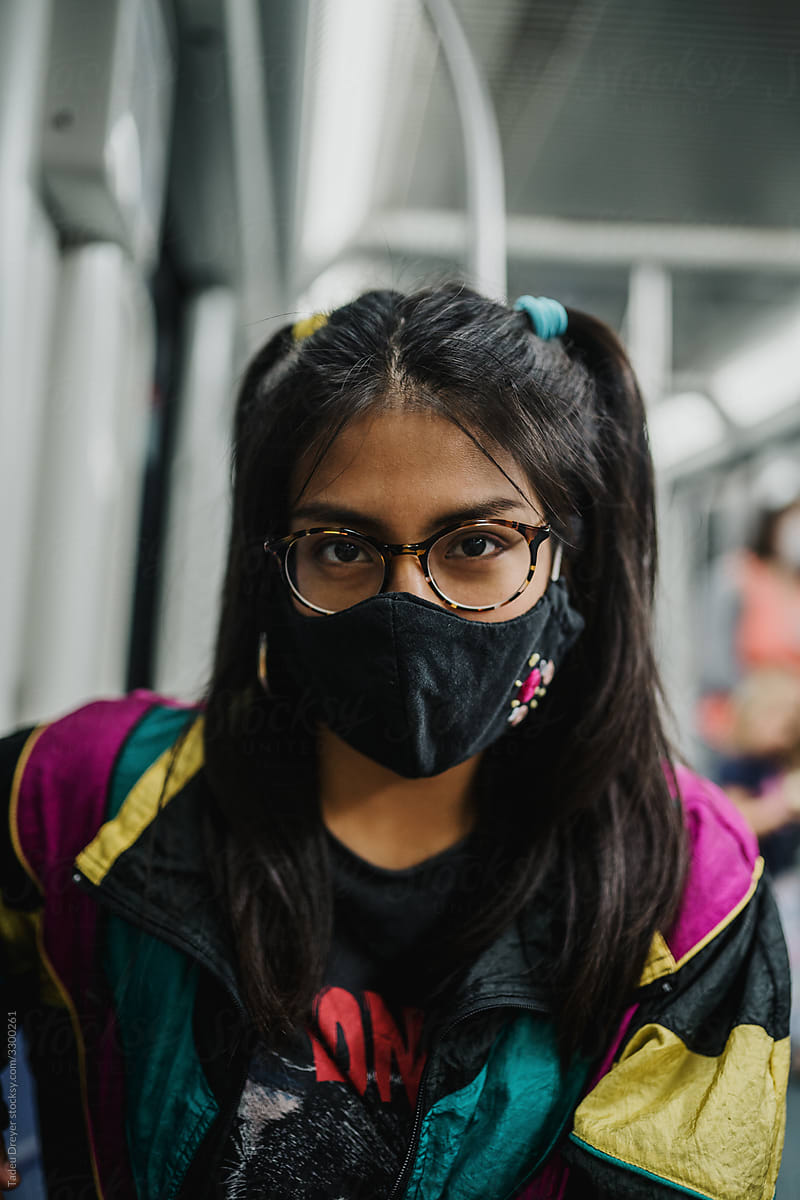 Young woman wearing a mask in the subway