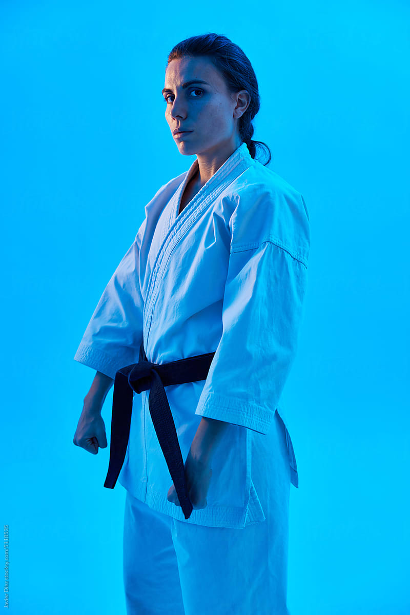 Woman in Karate uniform under blue light