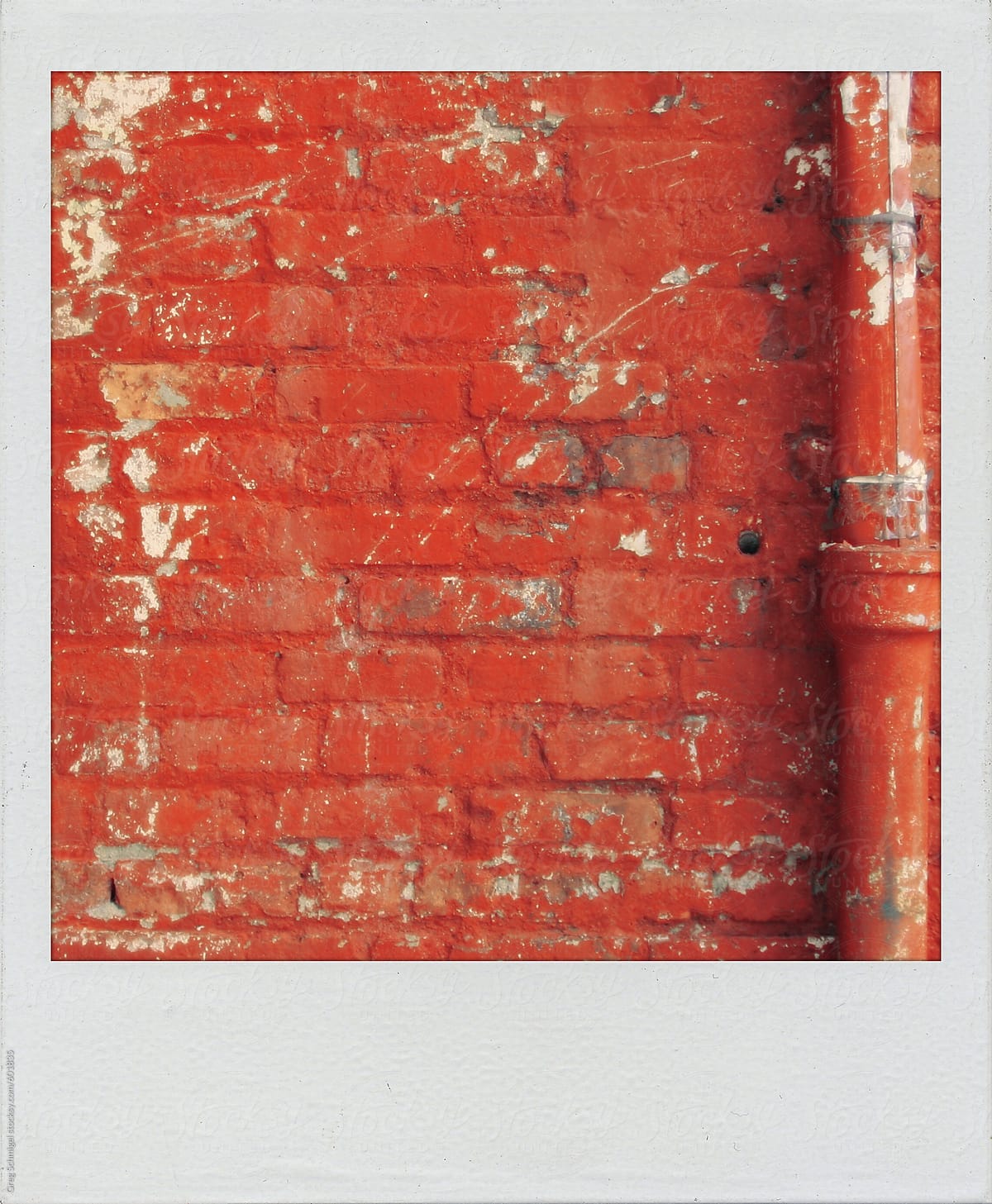 Old polaroid snapshot print of an eroded red brick wall texture