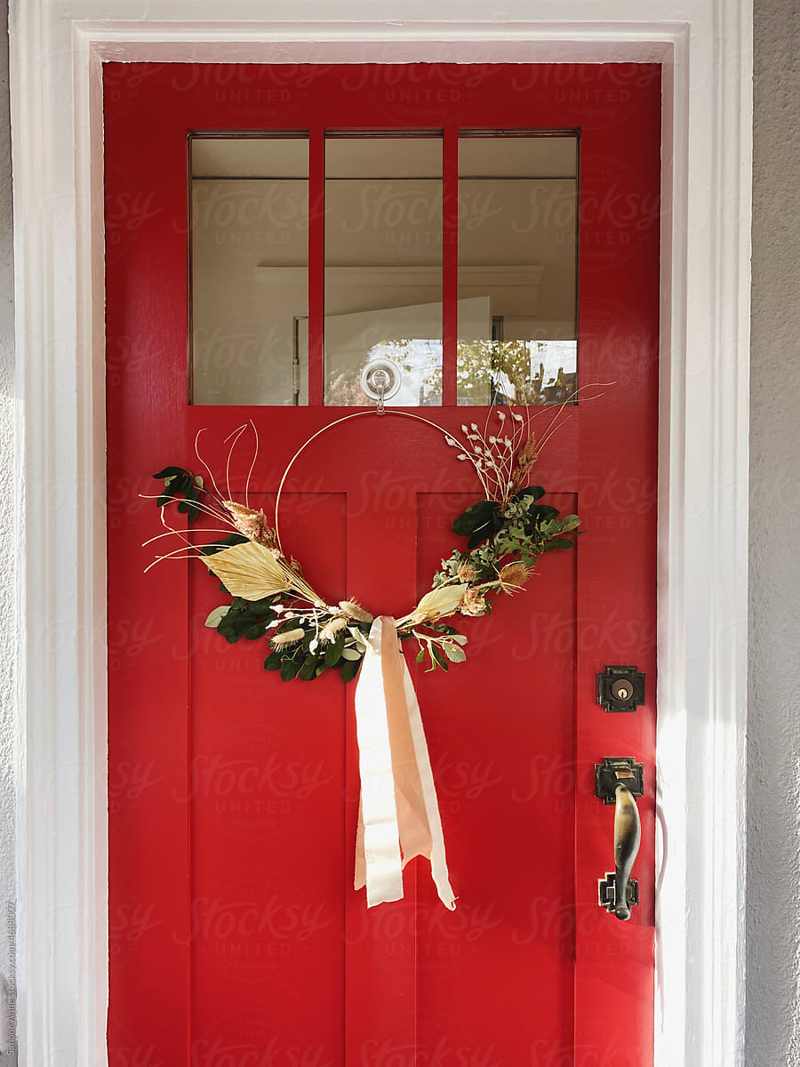 Modern wreath on red front door