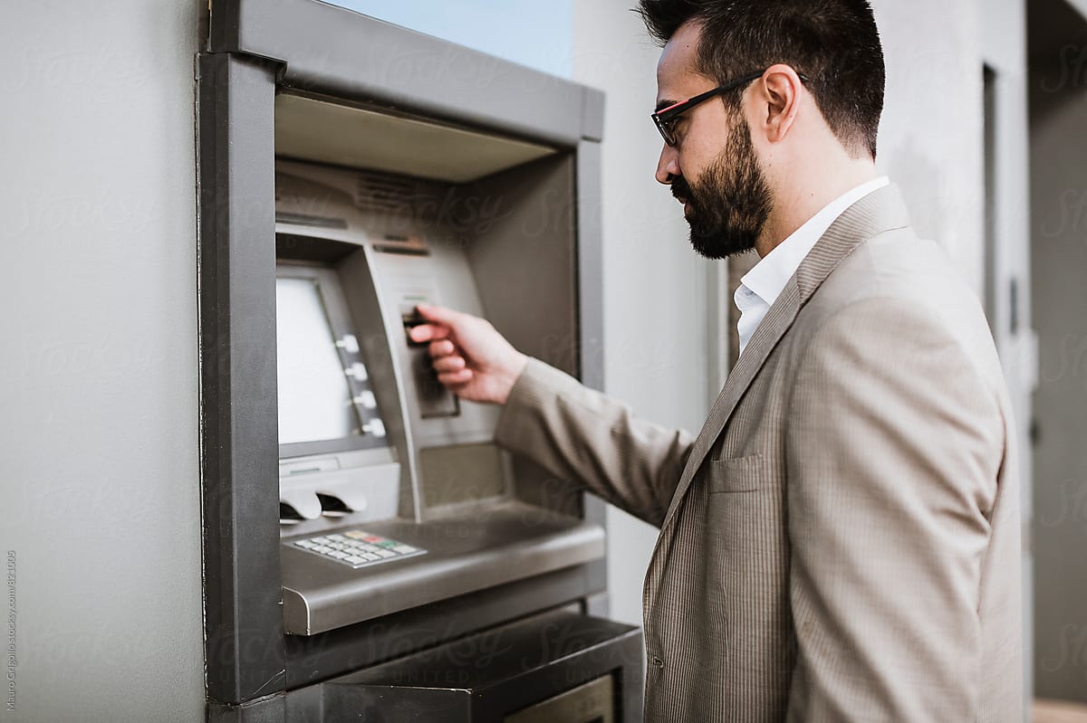 Businessman using an ATM to get money