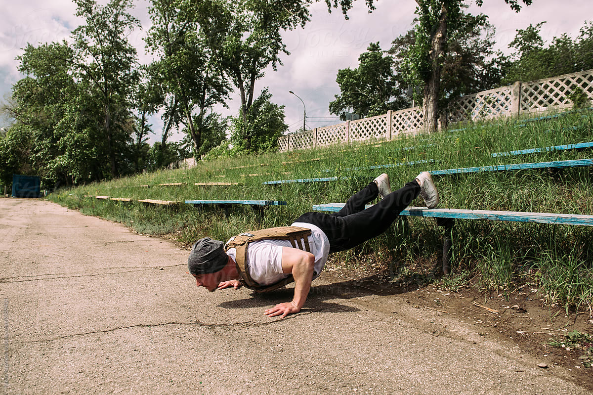 powerful street work-out of the crossfit athlete - doing push-ups in the playground