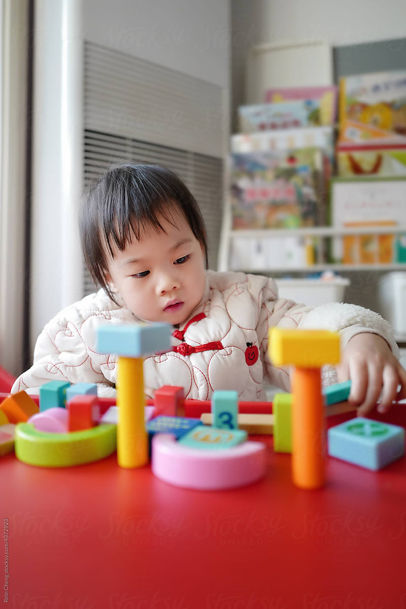 Asian baby building blocks alone