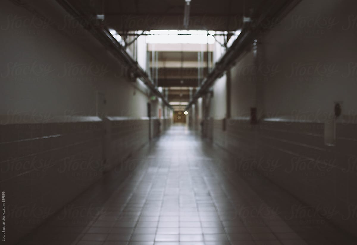 A really long hallway in a commercial space and out of focus.
