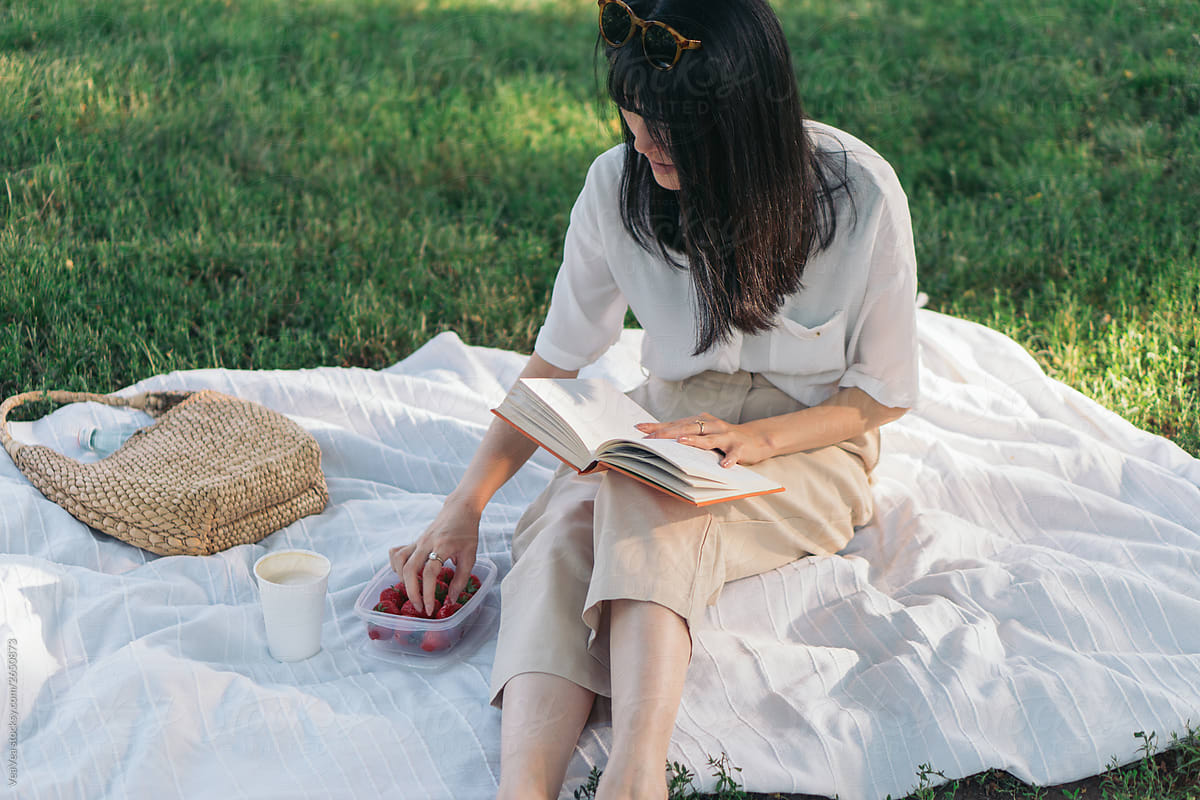 East Asian woman having a picnic in the park