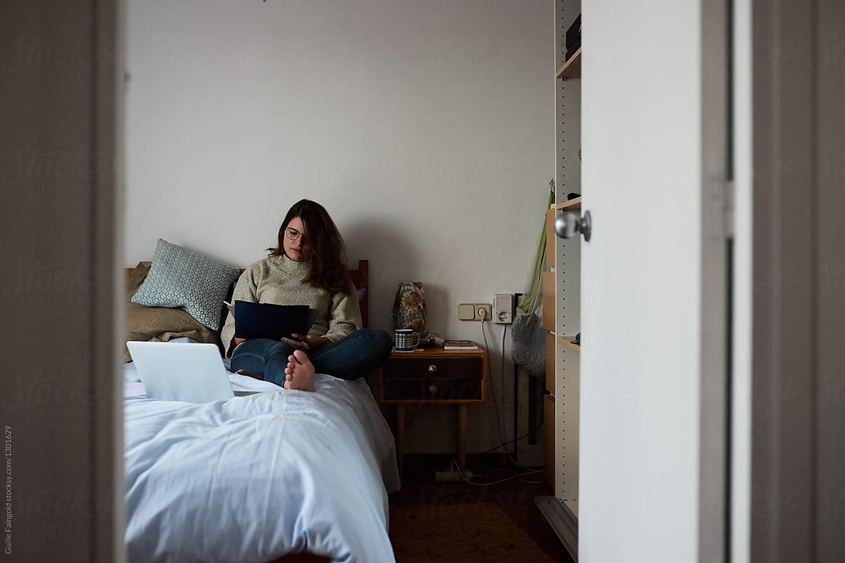 Brunette Teacher In Glasses Checking Homework On Bed By Stocksy Contributor Guille Faingold 6214