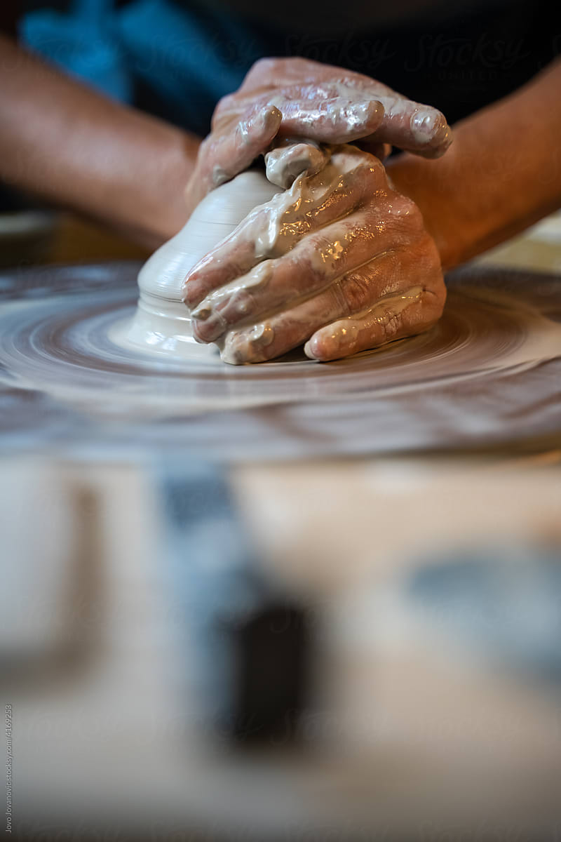 Centering clay on pottery wheel, closeup hands