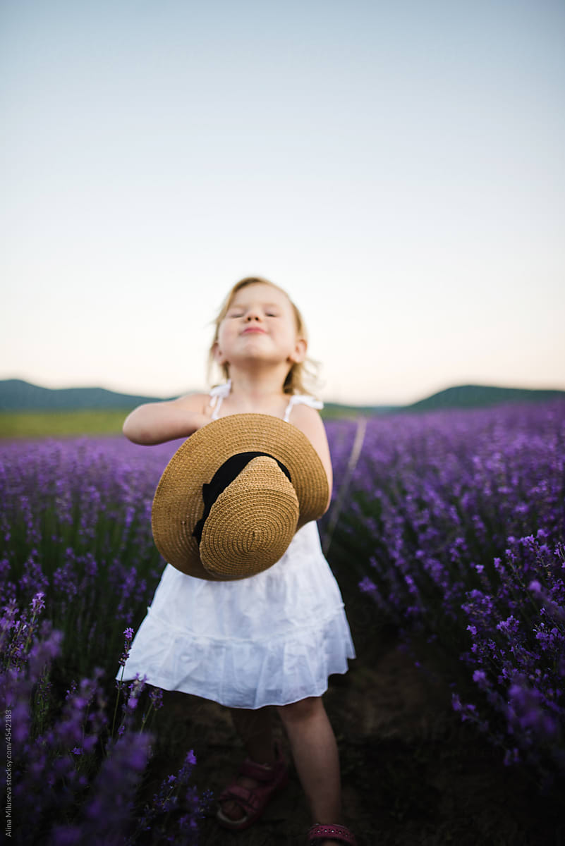 Portrait of cheerful little girl in blooming lavender field