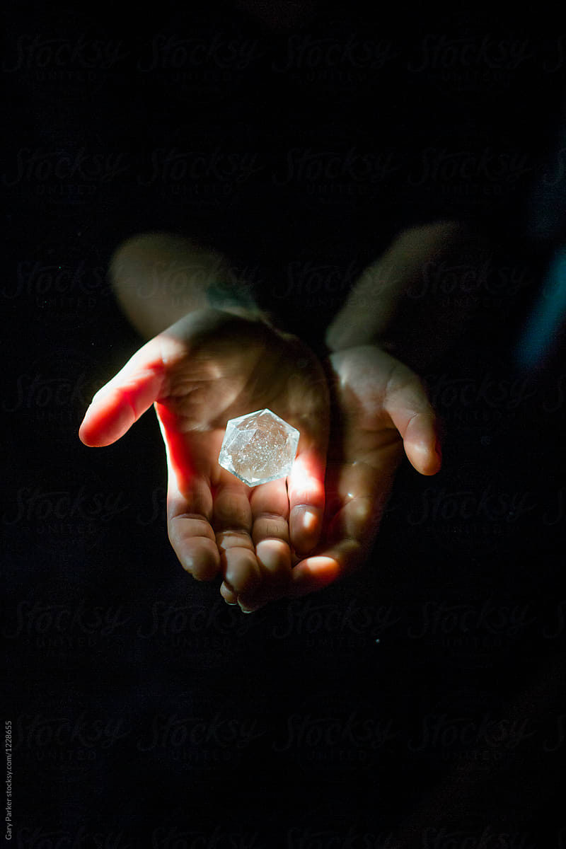 Female hands holding a crystal