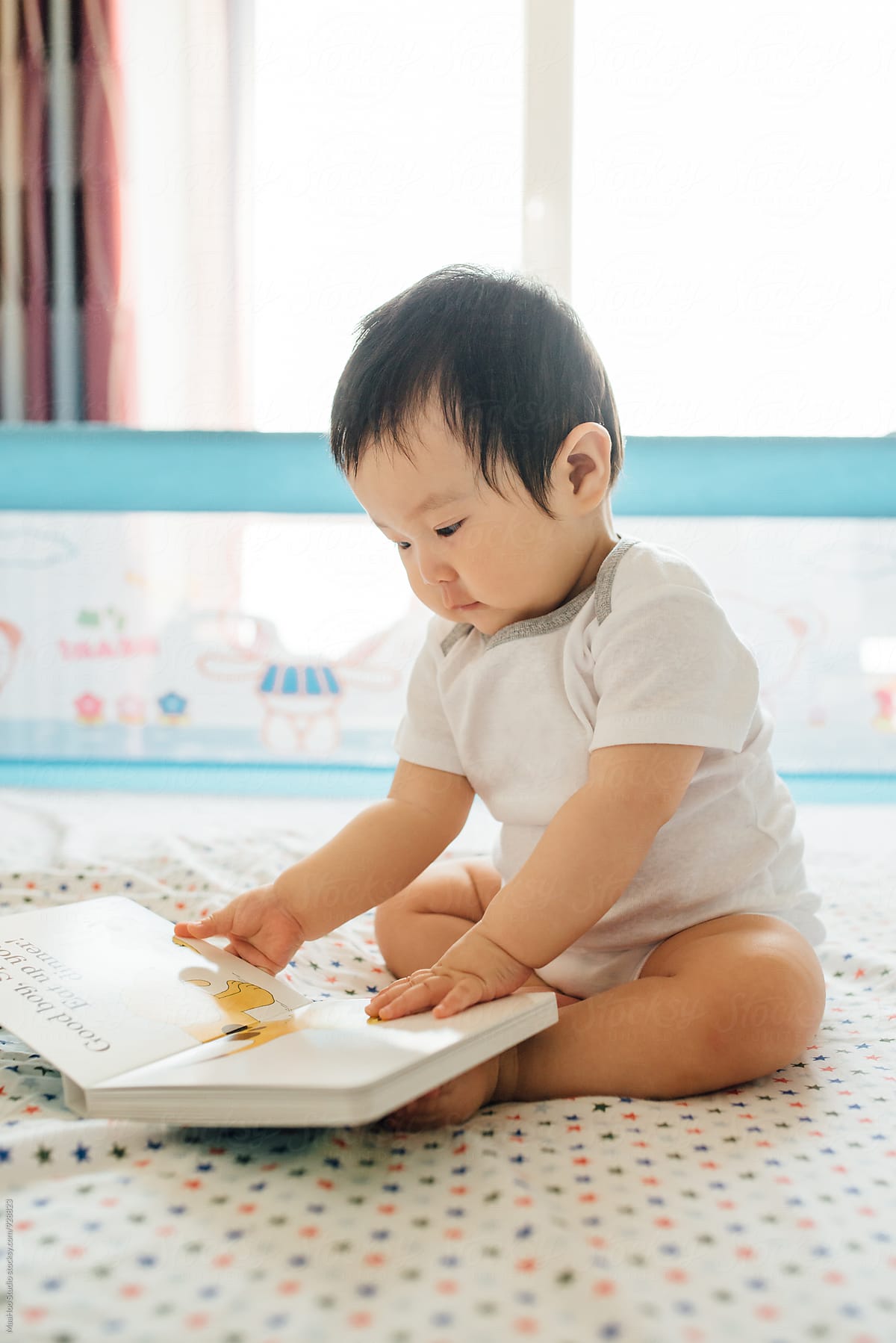 A Chinese baby boy reading books