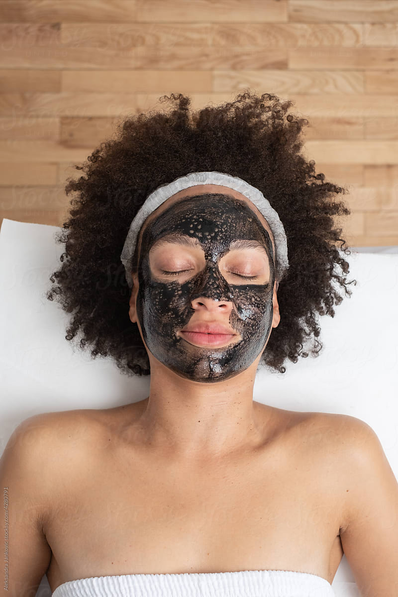 Woman Relaxing With Black Carbon Mask On Her Face