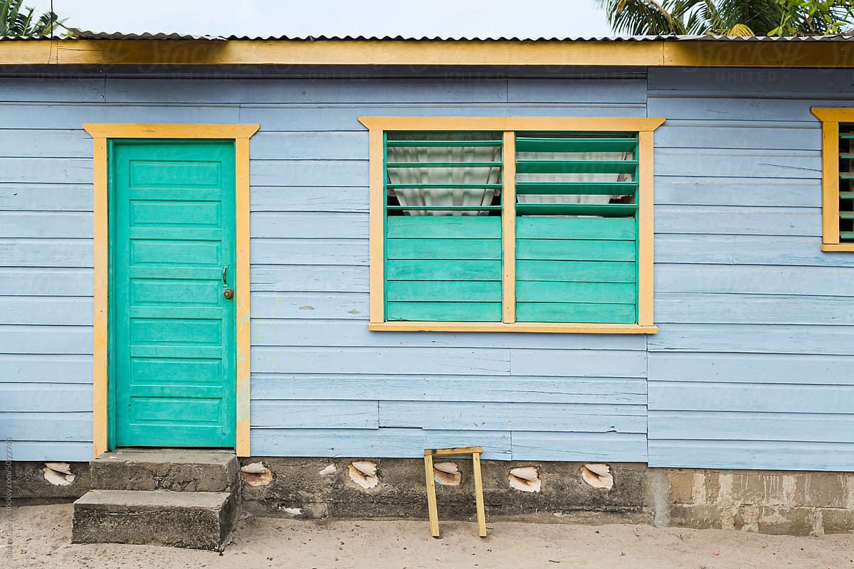 Blue wooden house with aqua door and window