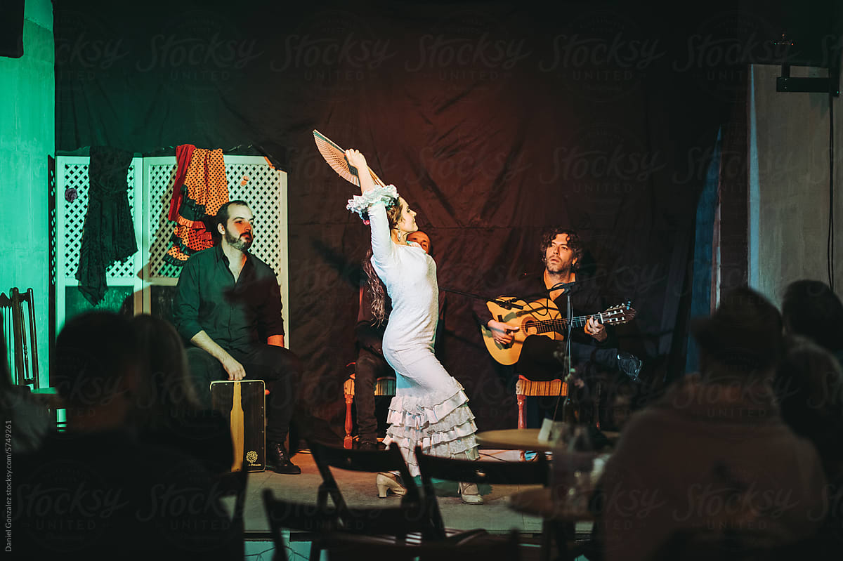 Musicians playing flamenco music and woman dancing