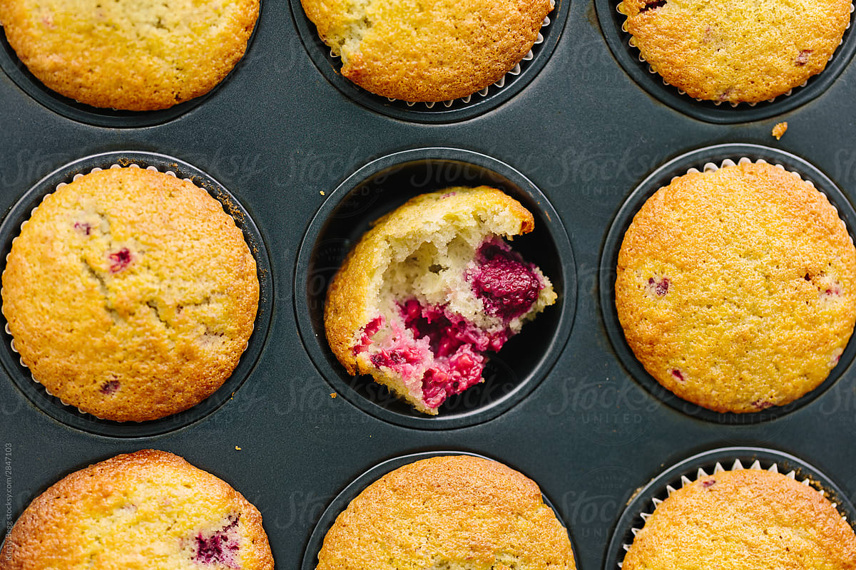 Split open raspberry muffin in tin