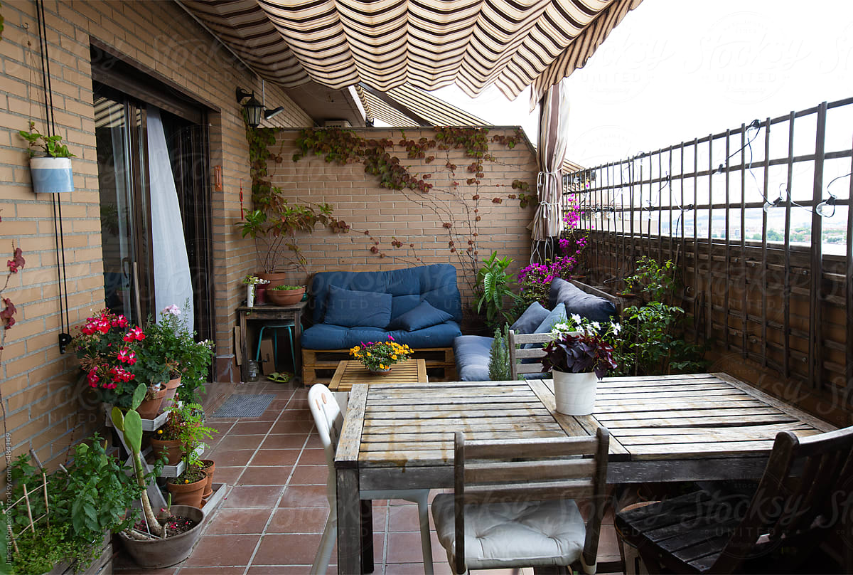 Terrace with diy cozy decor, striped owning and plants