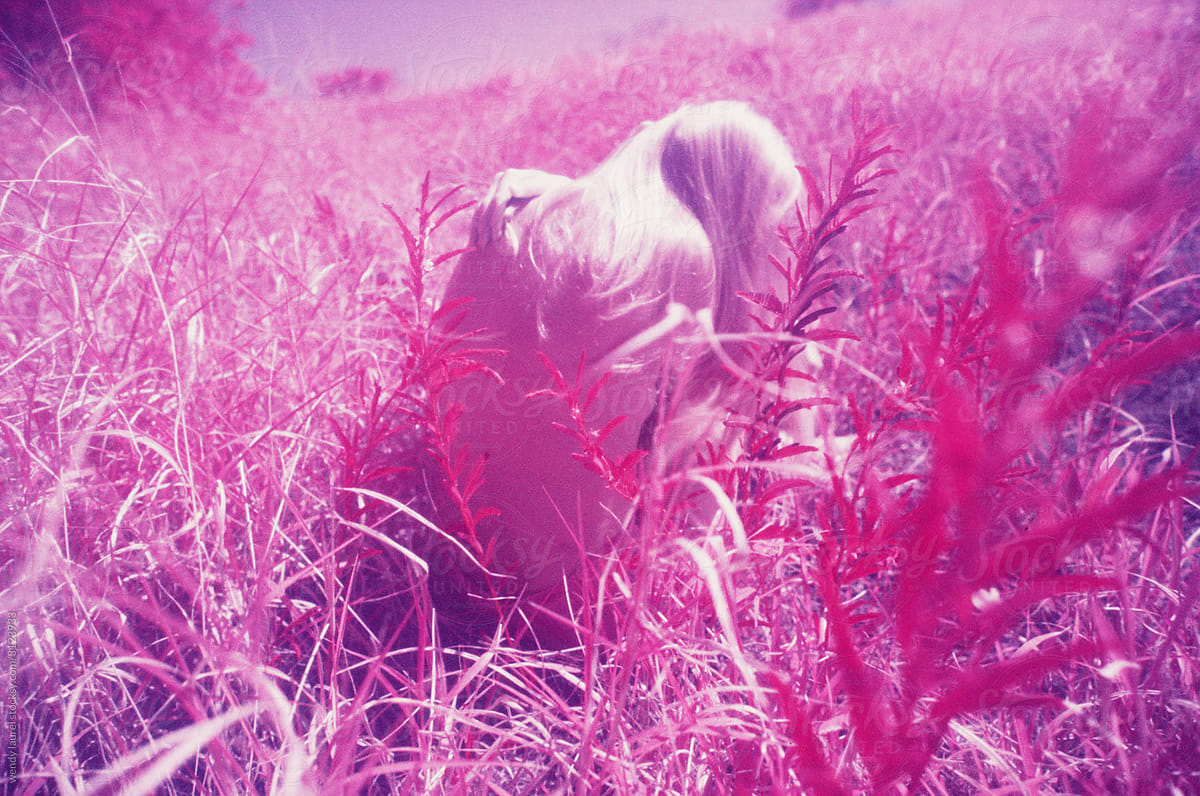 Pink infrared images of girl in a field grounding