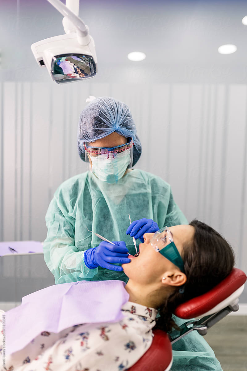 Dentist With A Patient During A Dental Intervention.