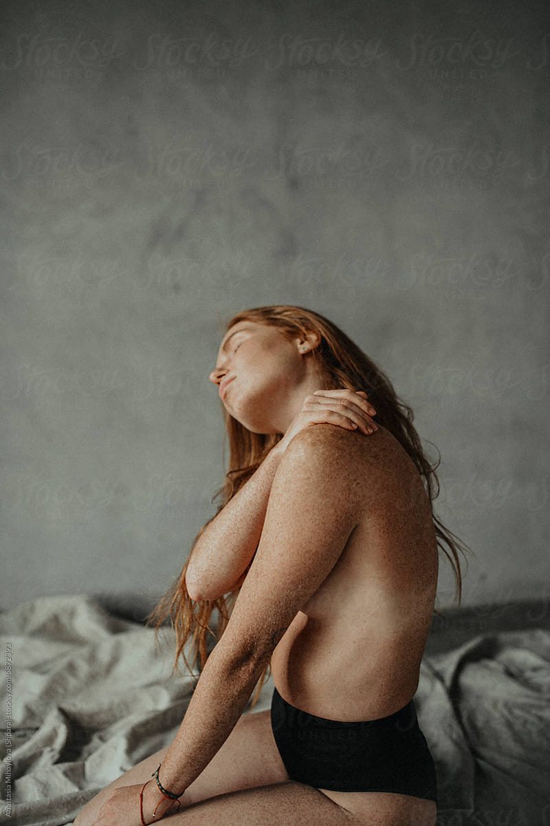 Woman's skin texture of Ginger female with many freckles on the body