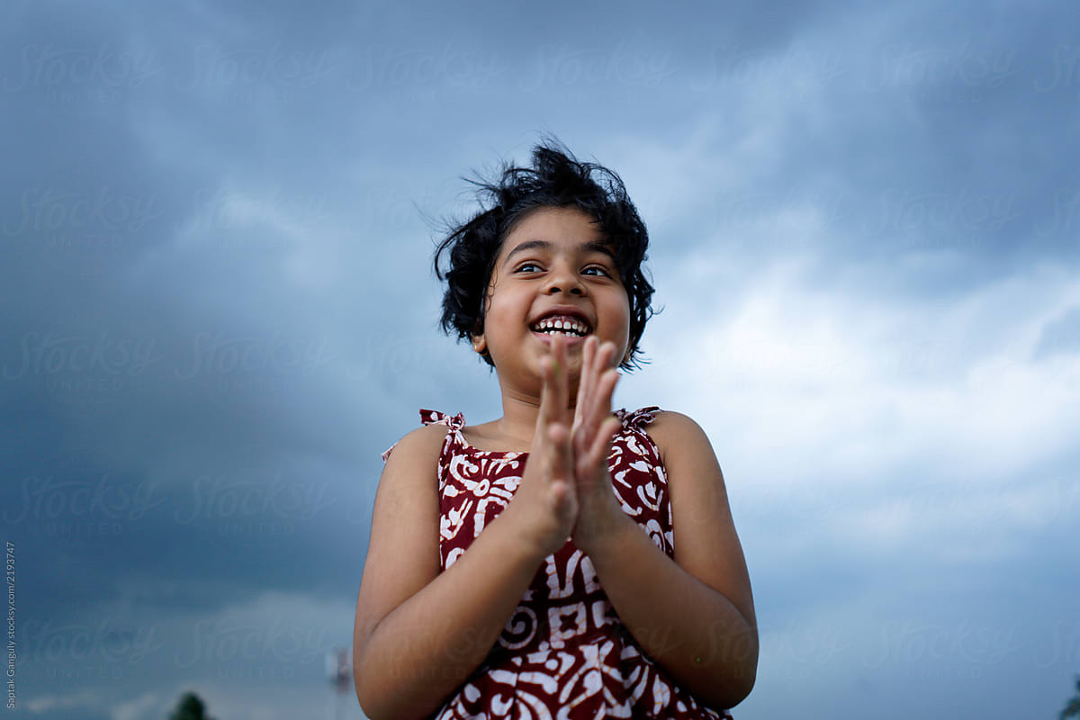 Little girl enjoying a cloudy monsoon day