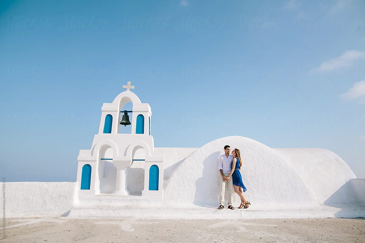 Couple standing near Greek chapel