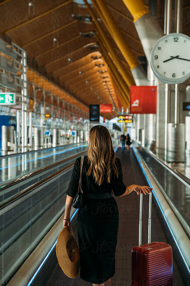 Traveler on moving walkway in airport