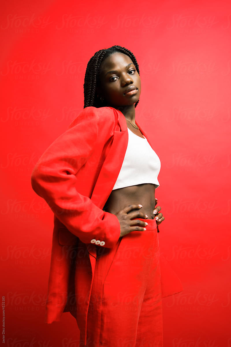 Black Woman In Classy Red Suit by Stocksy Contributor Javier