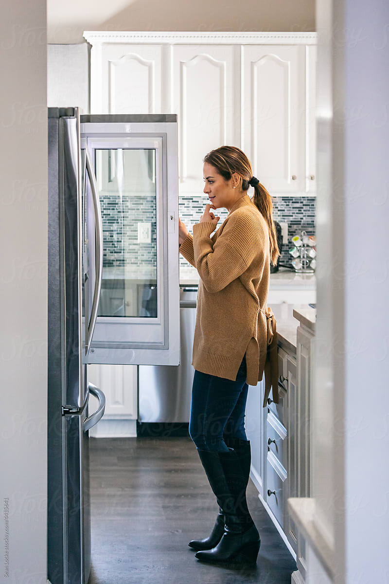 Kitchen: Woman Peers Into Refrigerator