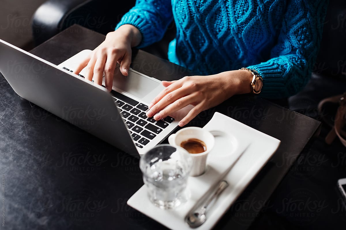 Woman works with her notebook in a cafe