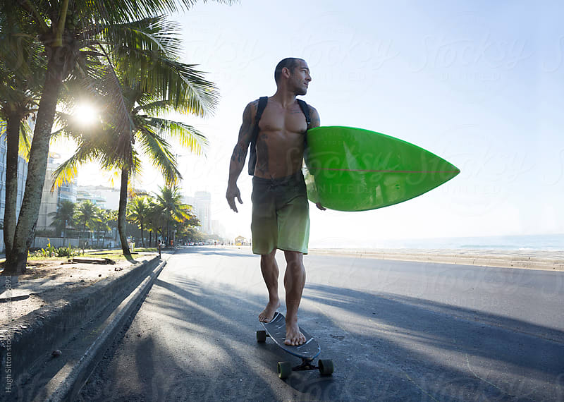 Surfer on Skateboard. Ipanema beach. Rio de Janeiro.