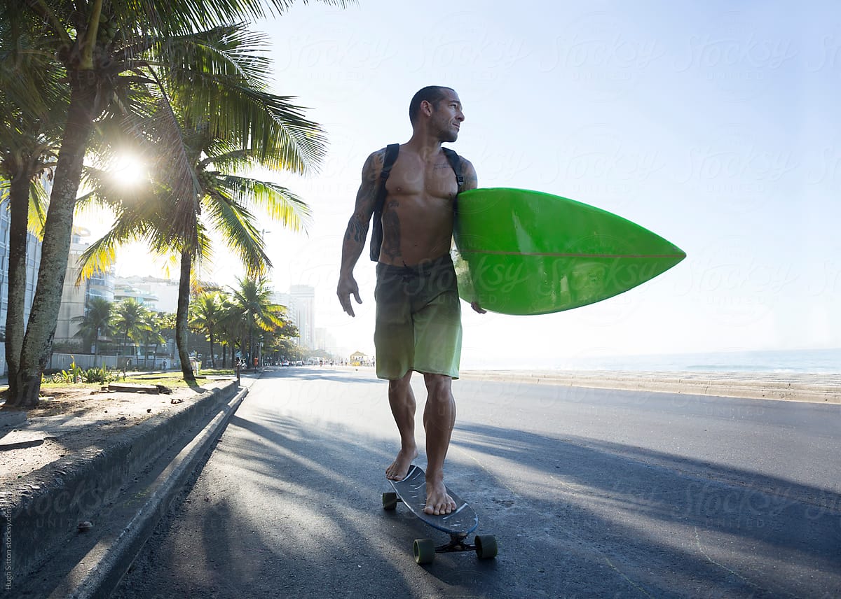 Surfer on Skateboard. Ipanema beach. Rio de Janeiro.