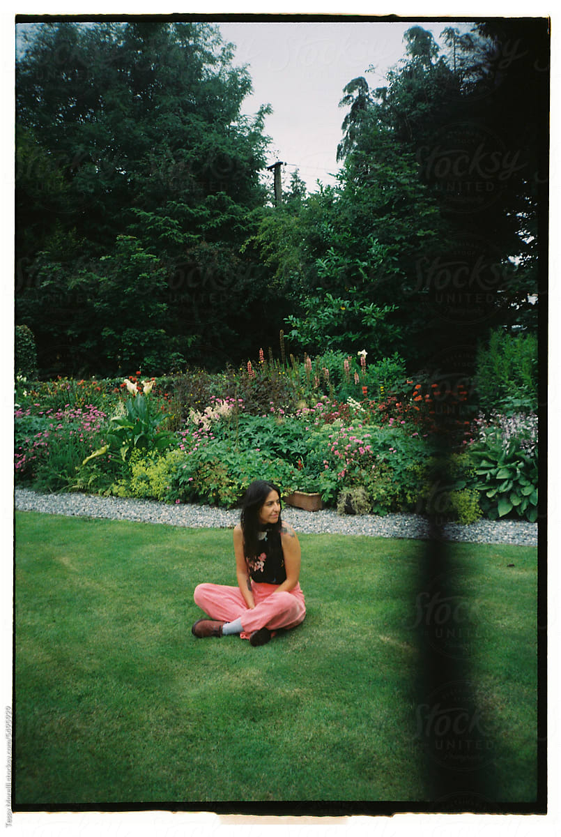 Film portrait of a woman sitting in the garden