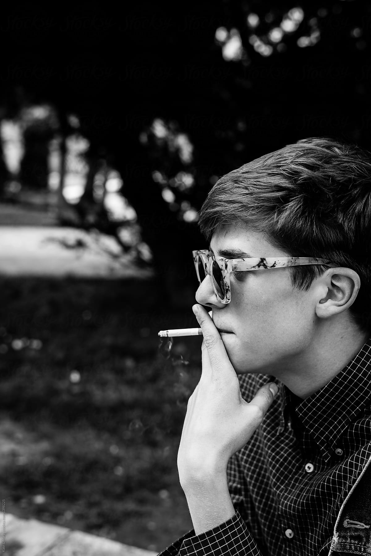 Young hip man smoking a cigarette