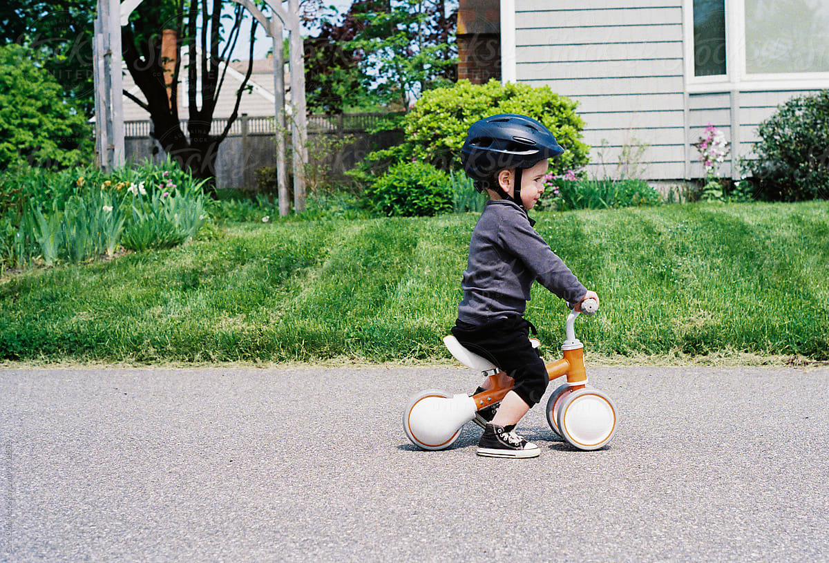 Cute Toddler with Helmet Riding Balance Bike
