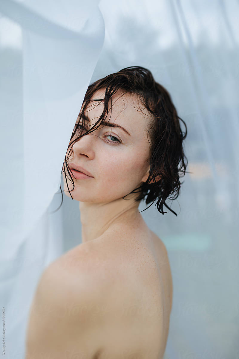 Portrait Of Naked Woman Sitting In Water by Stocksy Contributor