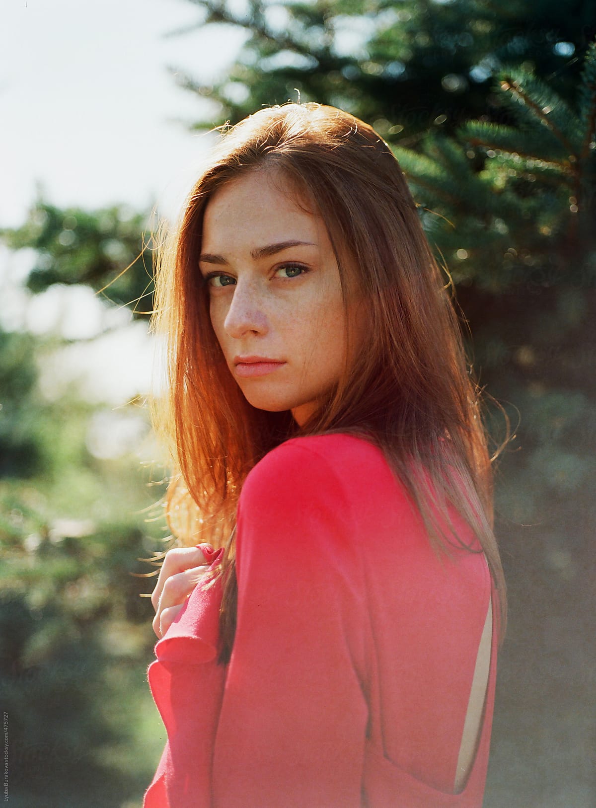 Portrait Of The Beautiful Woman In Red Dress Looking At Camera By Stocksy Contributor Amor 2494