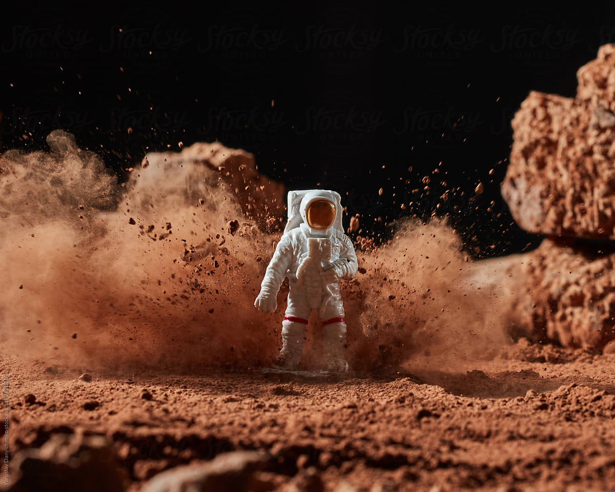 Cloud of cocoa powder around spaceman.