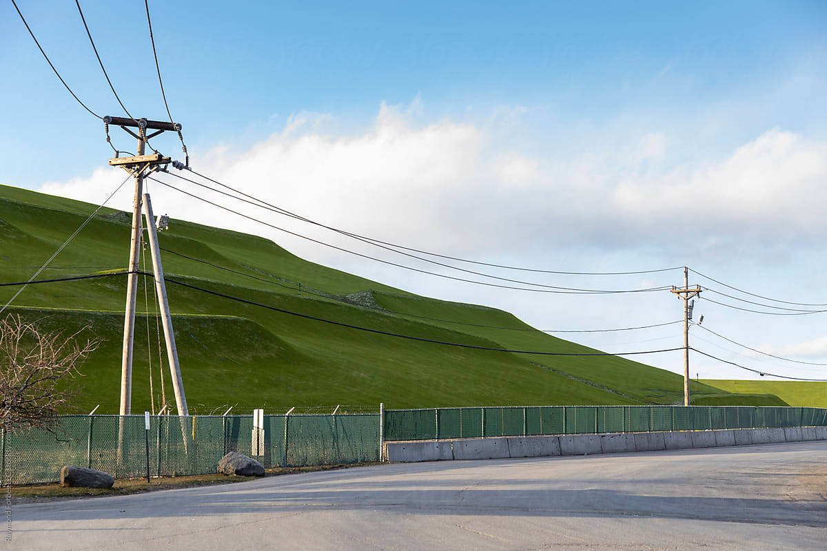 Landfill refuse landscape covered in grass nobody and power line