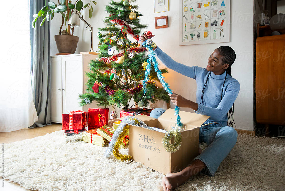 Woman at home putting out Christmas decorations