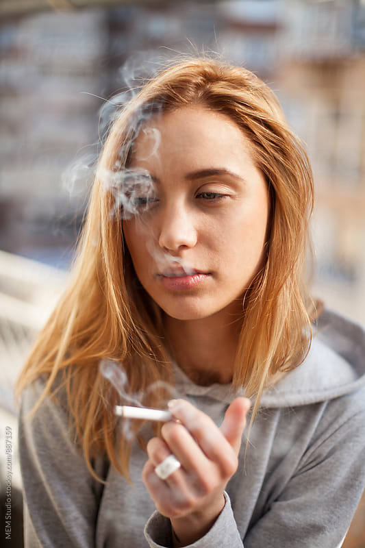 Attractive Young Woman Smoking Cigarette