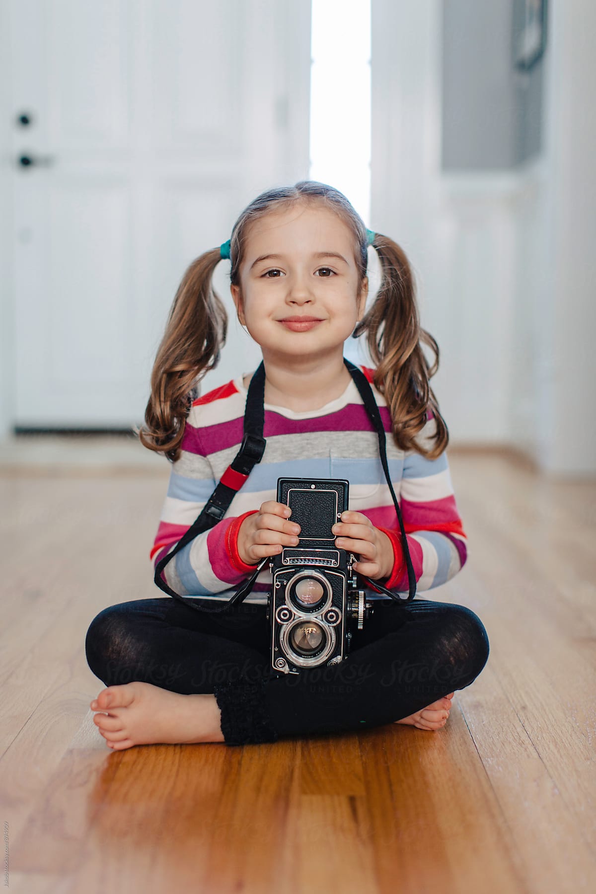 Cute Young Girl With Pigtails Using A Vintage Camera by Jakob ...