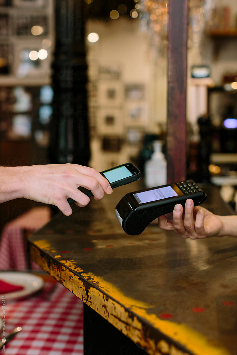 Hand holding a smart phone doing a wireless payment