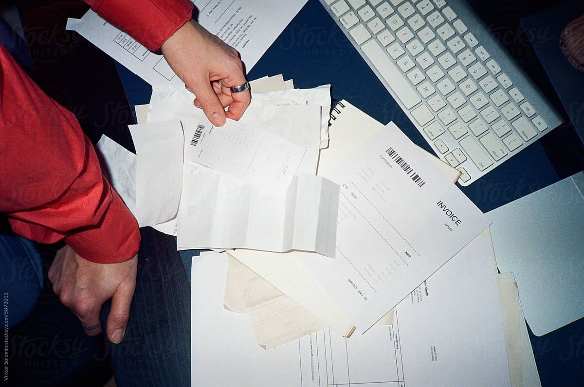 Crop woman hands working with business papers, invoices and receipts