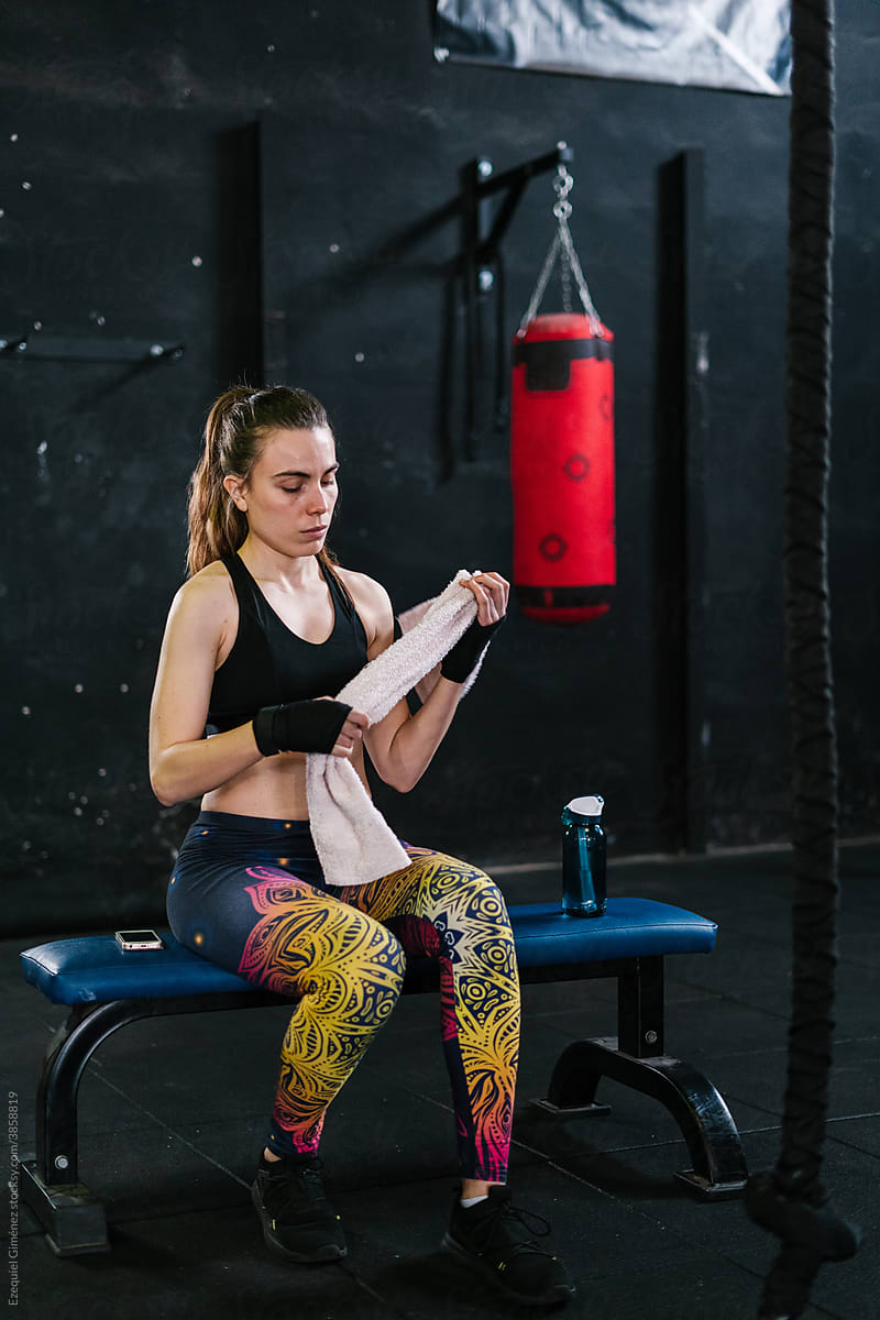 Athletic sportswoman resting after boxing workout