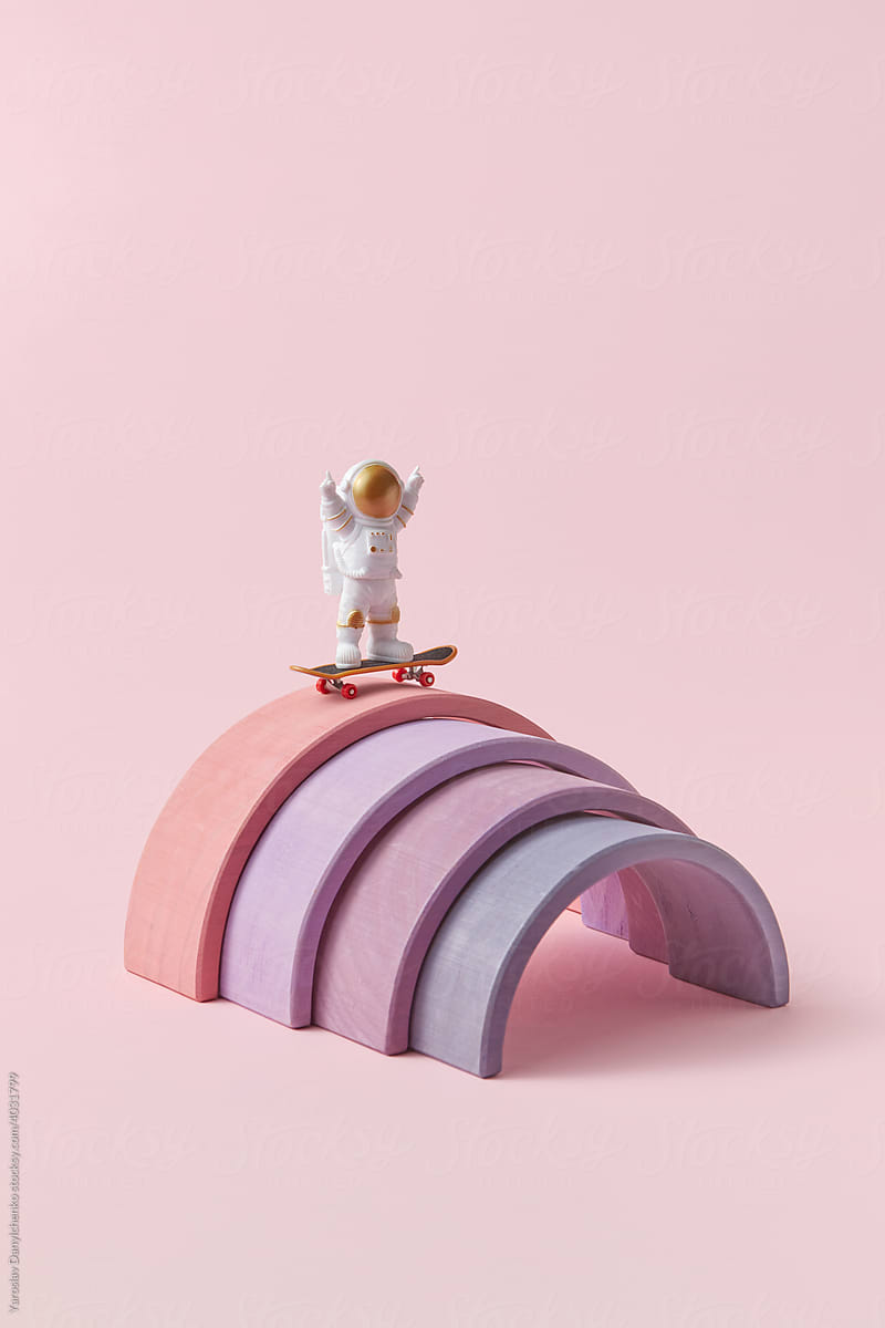 Astronaut in spacesuit standing with skateboard