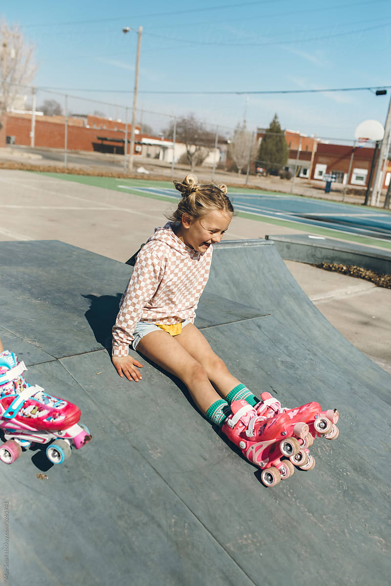 Kids sitting in their roller skates