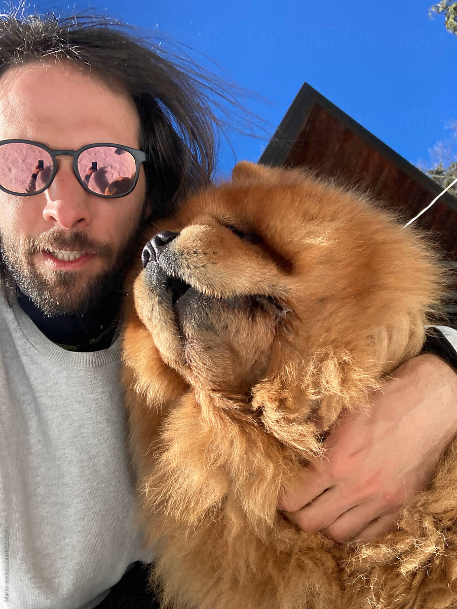 Selfie of a man and chow chow dog