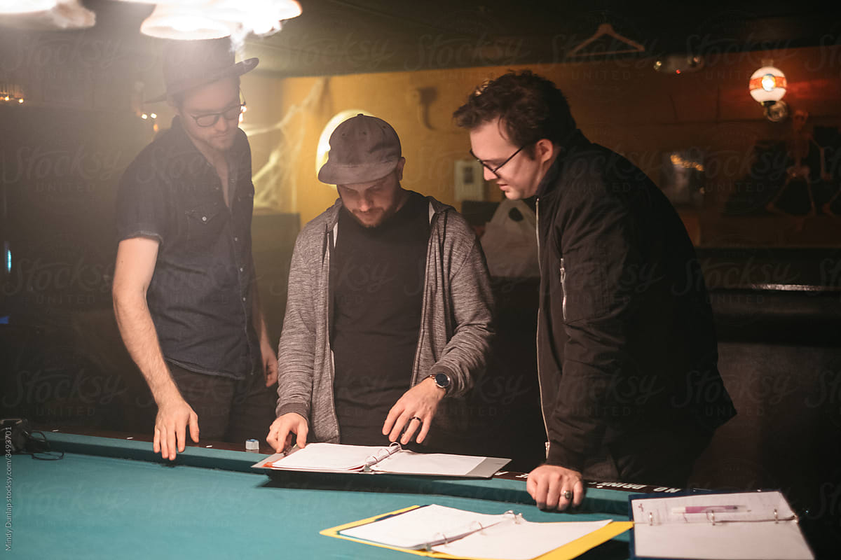 A film crew reviews a script before filming