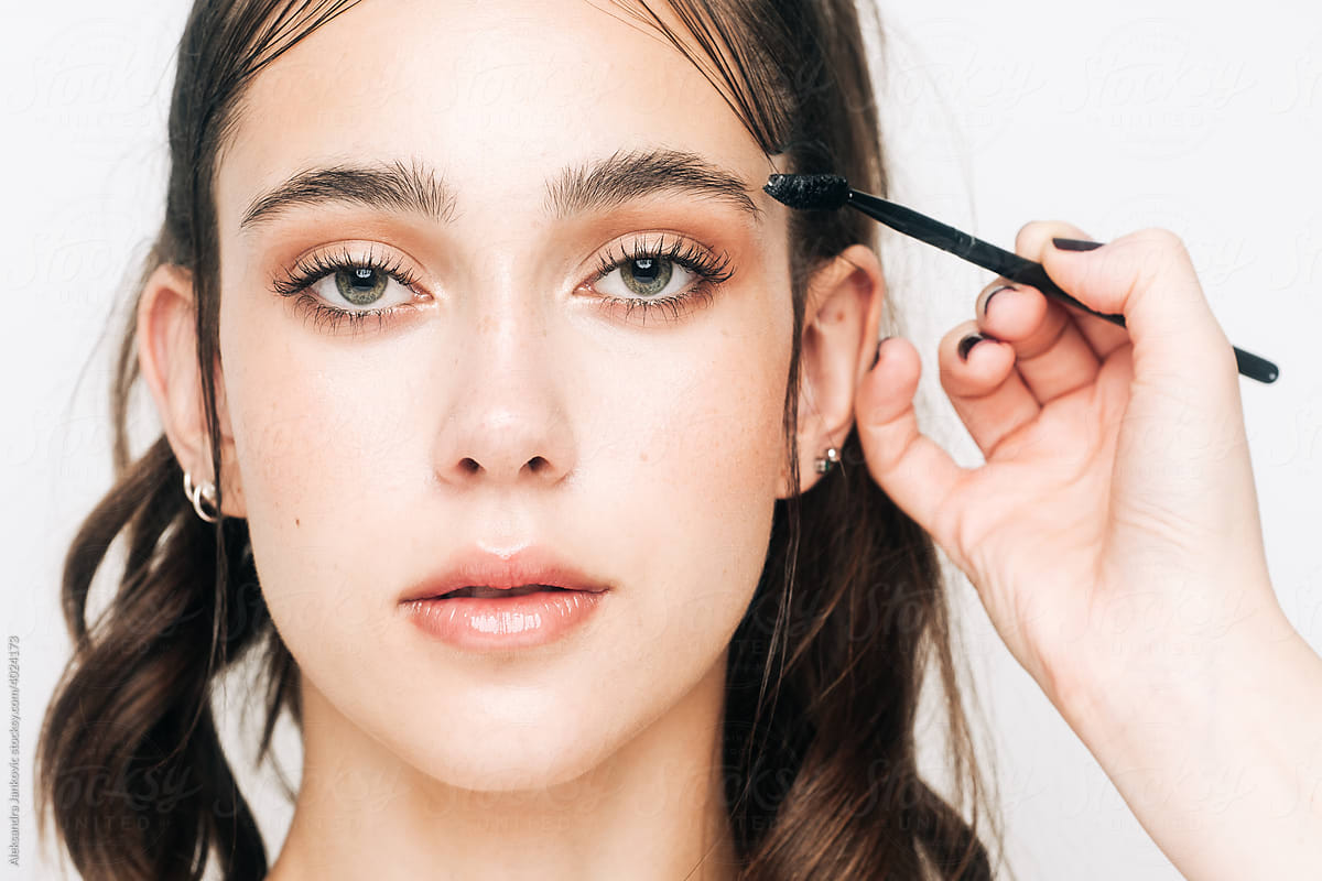 Makeup Artist Brushing Model\'s Eyebrows